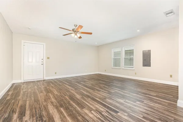 a living room with furniture a flat screen tv and a large window