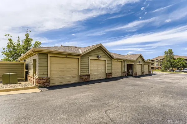 a view of a house with a yard and garage