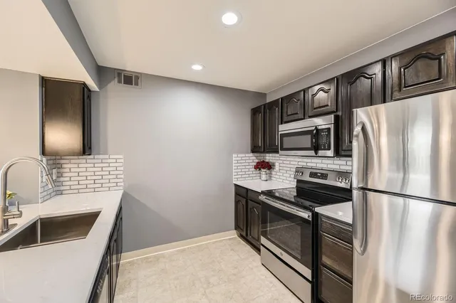 a view of an empty room with windows and fireplace