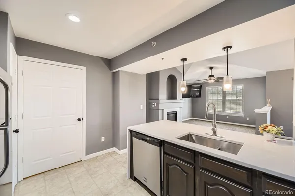 a view of an empty room with windows and fireplace