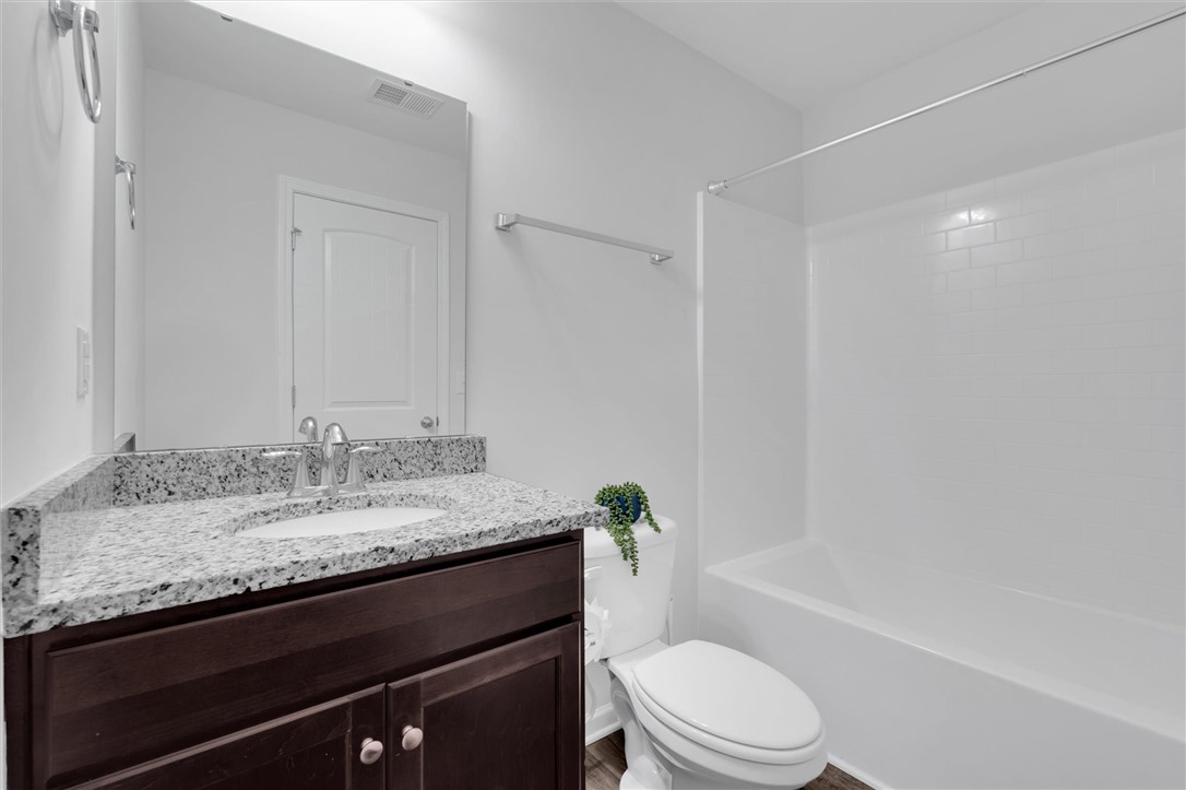 215 Royal Way Pendleton, SC 29670 - Photo 21 of 31 This clean bathroom features a spacious vanity with elegant granite countertops and a pristine white bathtub.