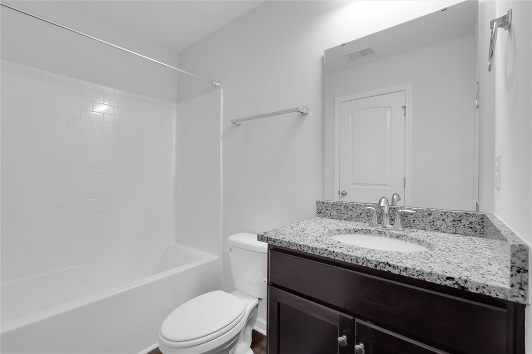 215 Royal Way Pendleton, SC 29670 - Photo 23 of 31 This bathroom features a sleek vanity with granite counters and a clean tub.