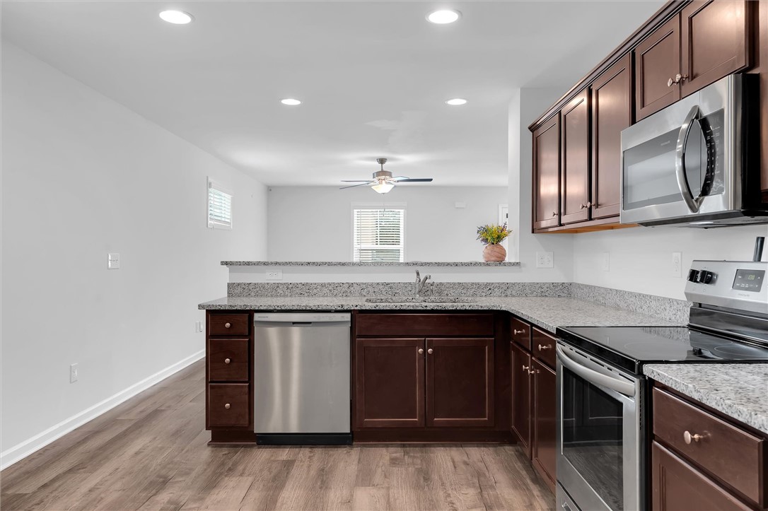 215 Royal Way Pendleton, SC 29670 - Photo 10 of 31 This modern kitchen features rich cabinetry, sleek countertops, and stainless steel appliances.