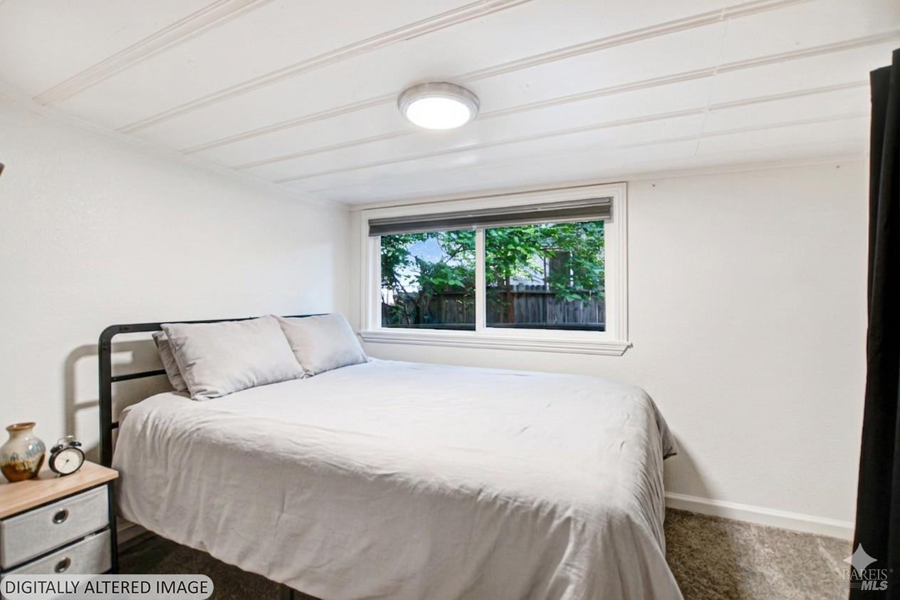15289 Willow Road Guerneville, CA 95446 - Photo 13 of 22 a bedroom with a bed and a window