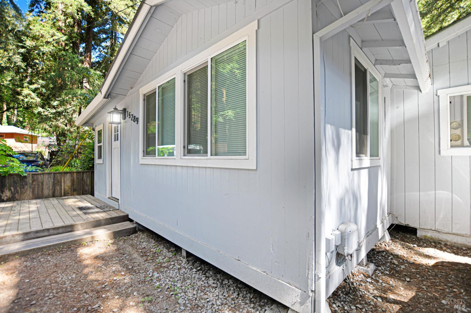 15289 Willow Road Guerneville, CA 95446 - Photo 21 of 22 a view of a porch with a floor to ceiling window and wooden fence