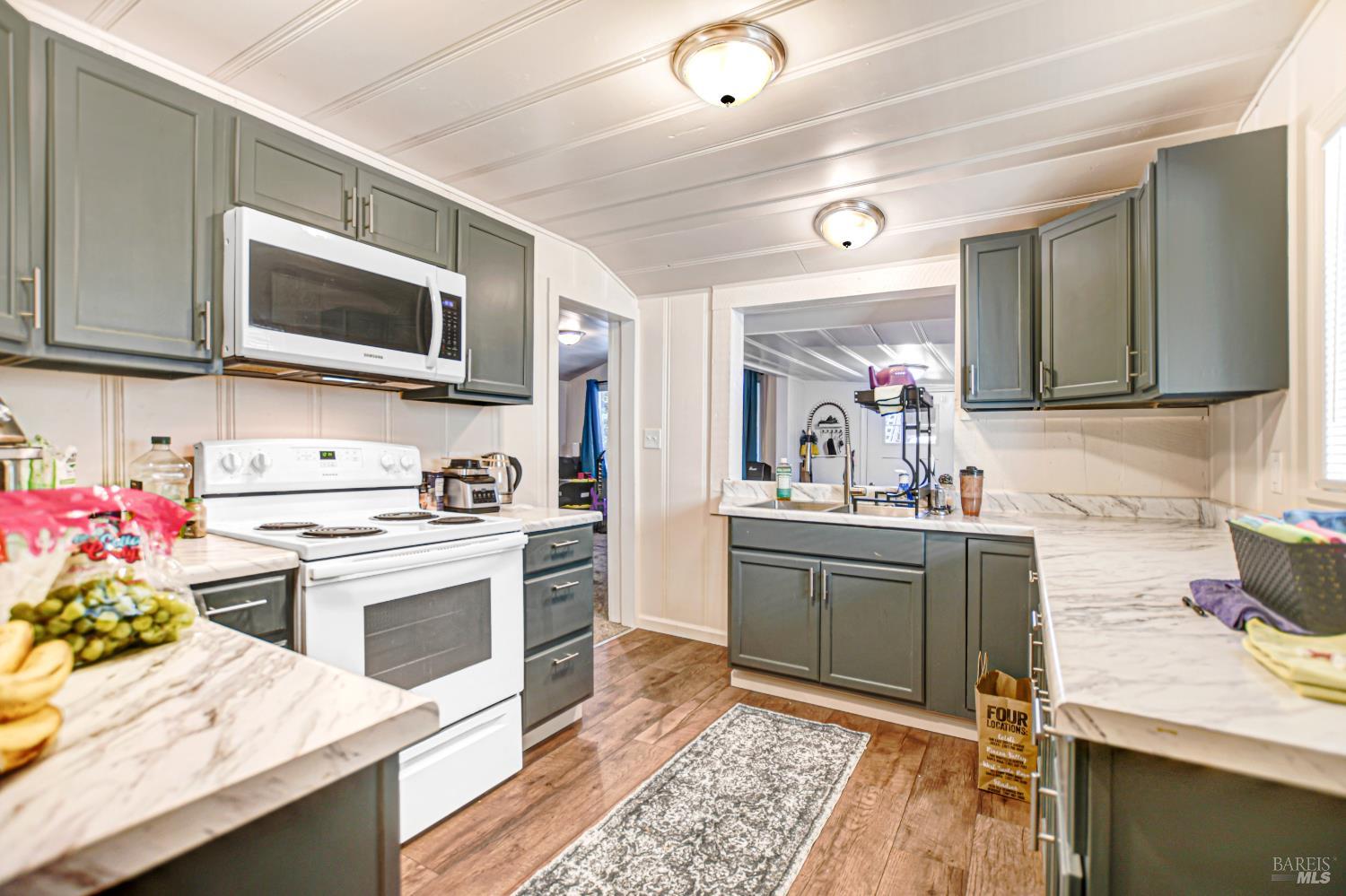 15289 Willow Road Guerneville, CA 95446 - Photo 3 of 22 a kitchen with a sink stove and microwave