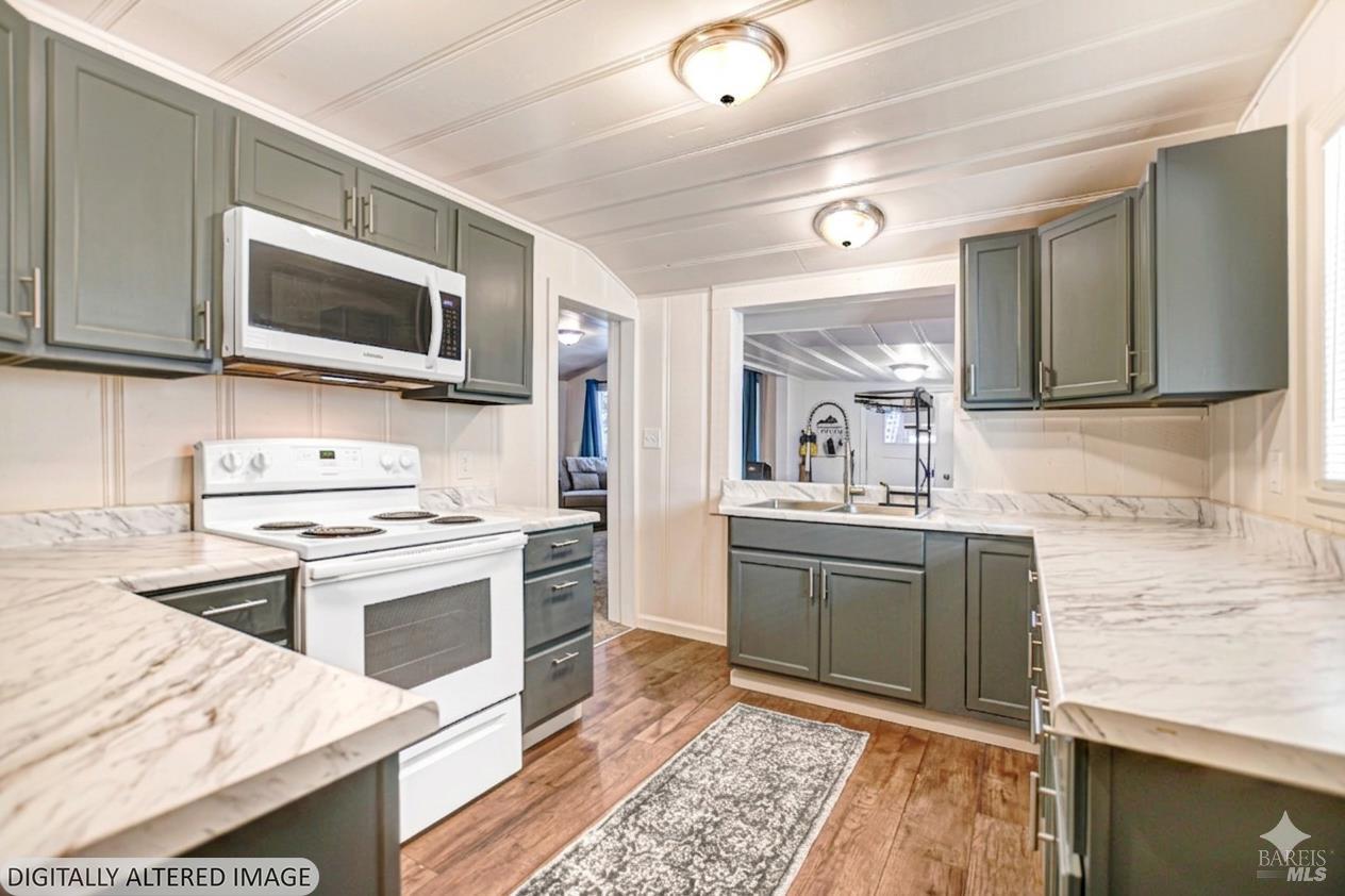 15289 Willow Road Guerneville, CA 95446 - Photo 4 of 22 a kitchen with stainless steel appliances granite countertop a sink stove and microwave