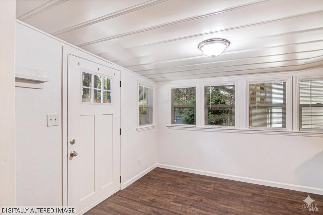 15289 Willow Road Guerneville, CA 95446 - Photo 7 of 22 a view of an empty room with wooden floor and a window