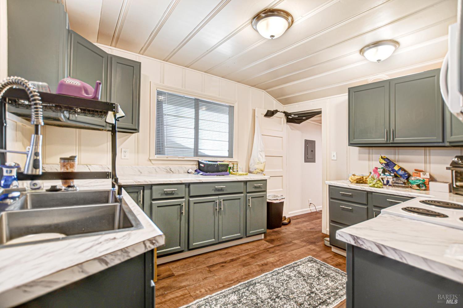 15289 Willow Road Guerneville, CA 95446 - Photo 8 of 22 a kitchen with a sink stove and cabinets