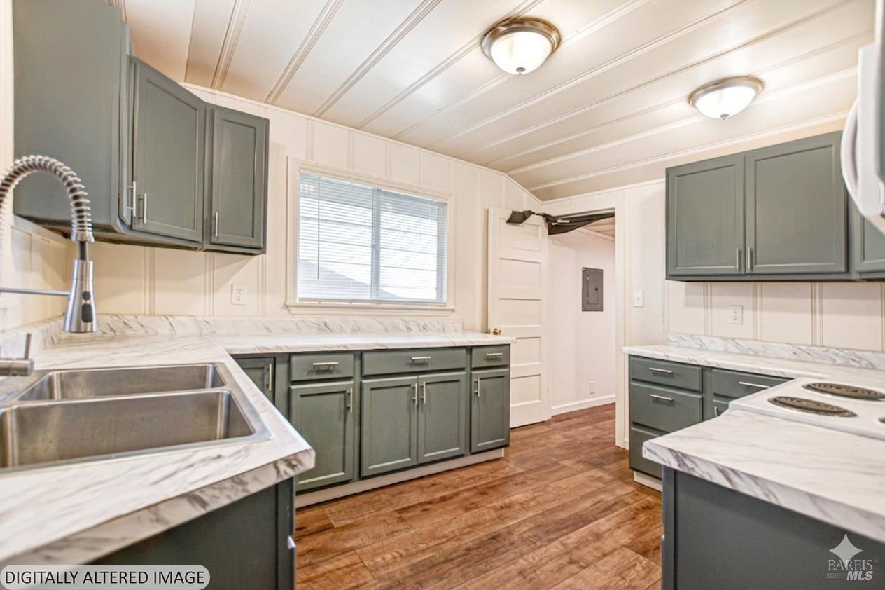 15289 Willow Road Guerneville, CA 95446 - Photo 9 of 22 a kitchen with stainless steel appliances granite countertop a sink stove and refrigerator