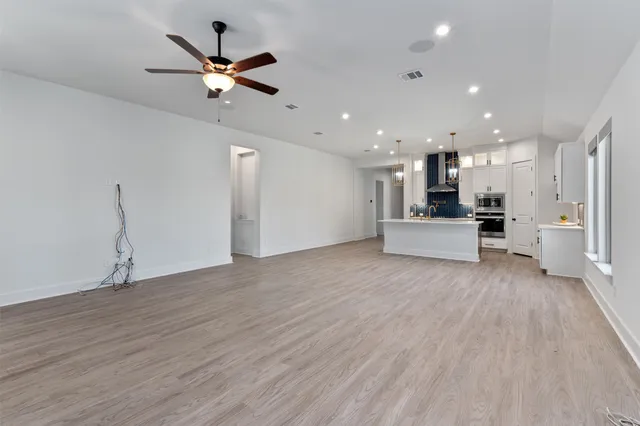 a view of kitchen with cabinets and wooden floor