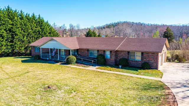 a view of house with yard and swimming pool