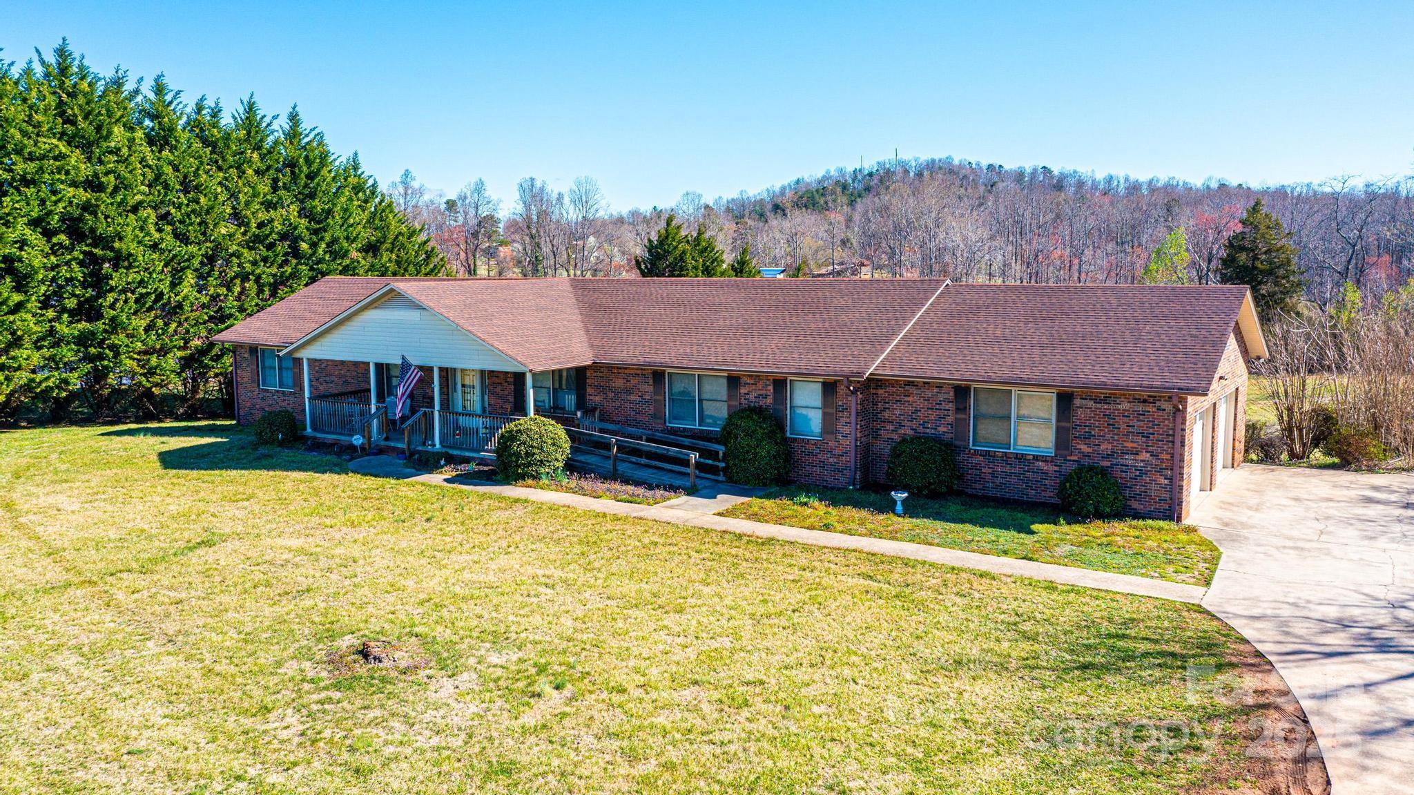 a view of house with yard and swimming pool