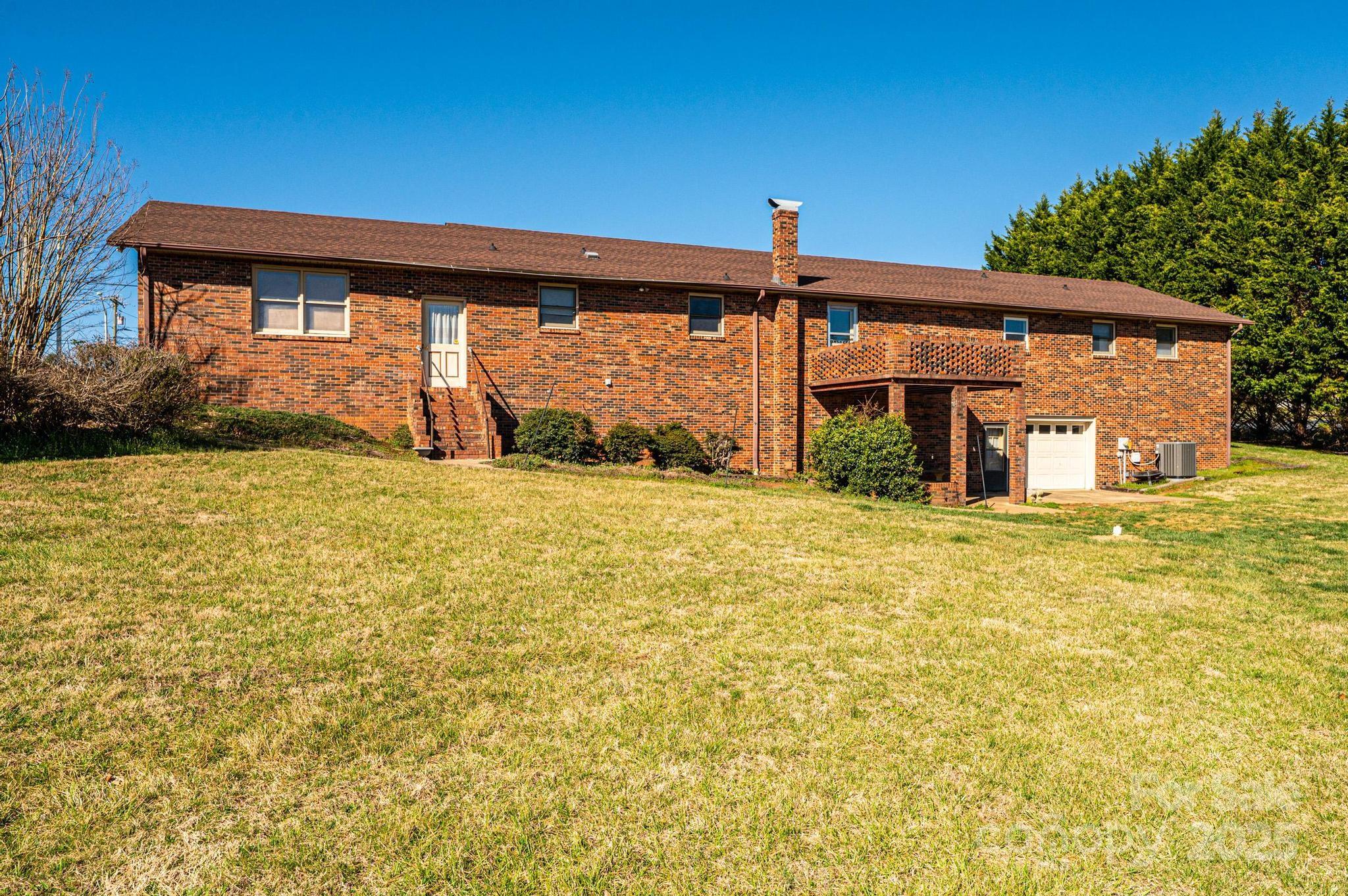 1221 Connelly Springs Road Lenoir, NC 28645 - Photo 11 of 42 a view of house with backyard
