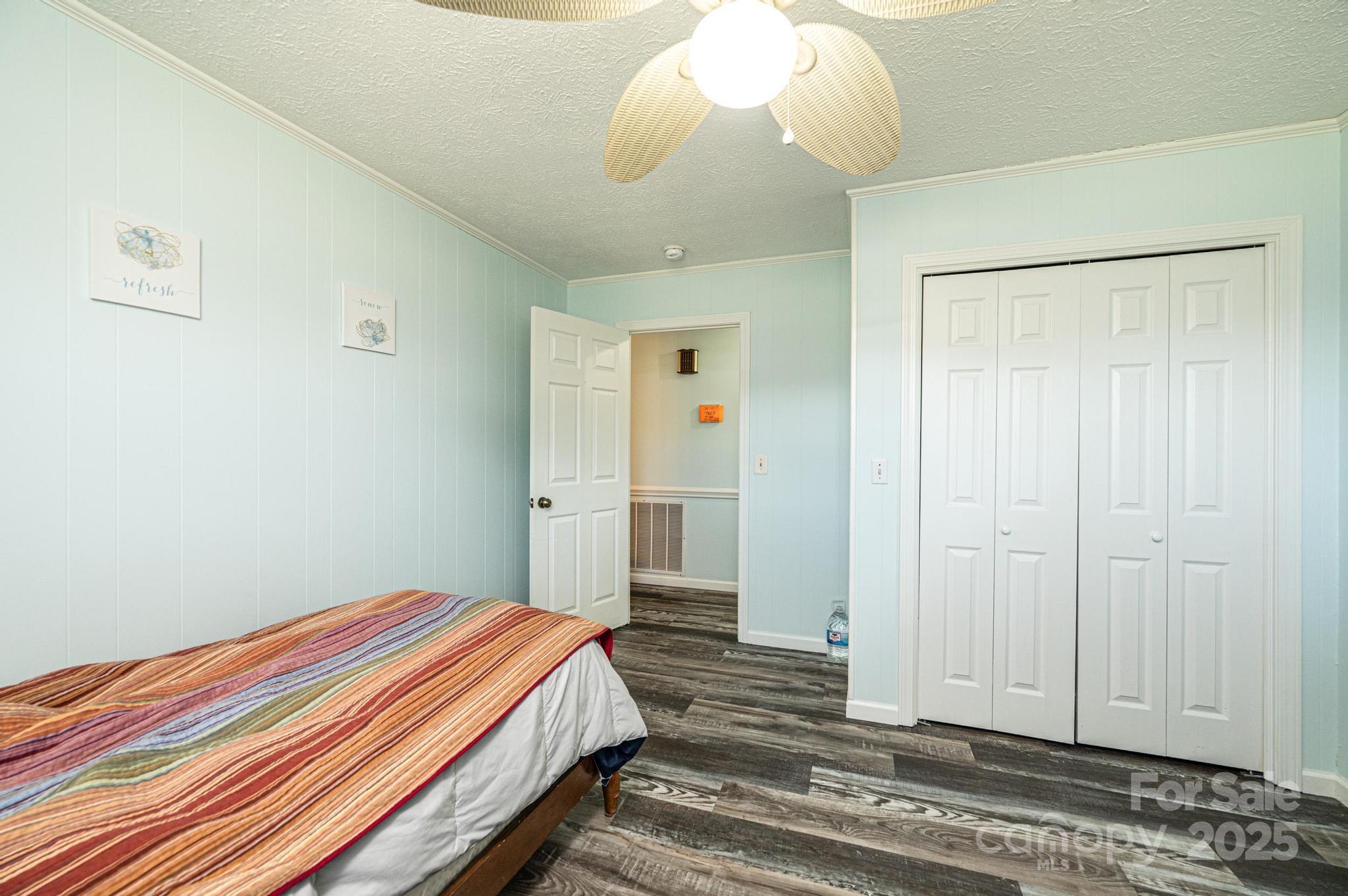 1221 Connelly Springs Road Lenoir, NC 28645 - Photo 18 of 42 a bedroom with a bed and a chandelier