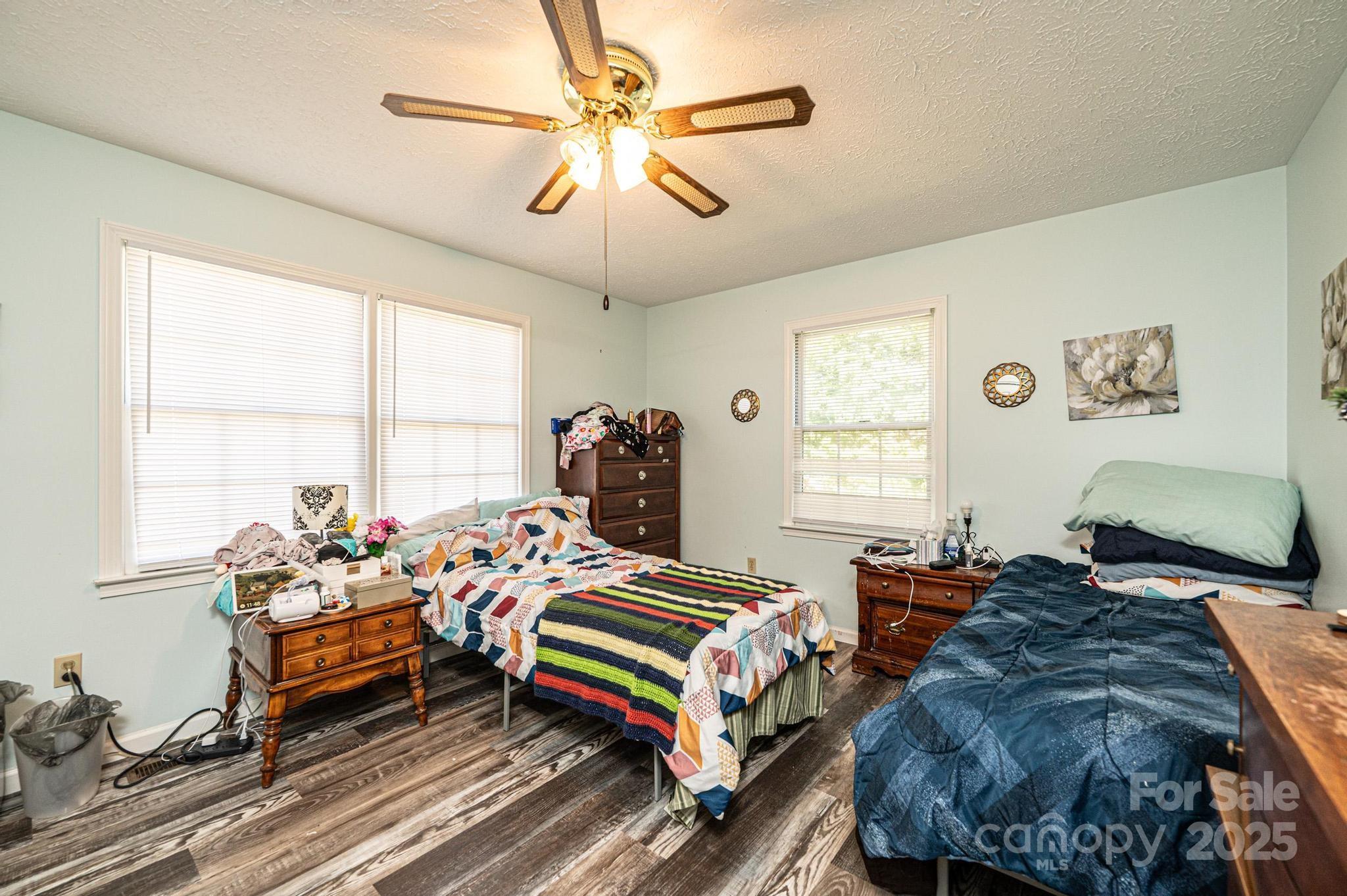 1221 Connelly Springs Road Lenoir, NC 28645 - Photo 22 of 42 a bedroom with two beds and a chandelier