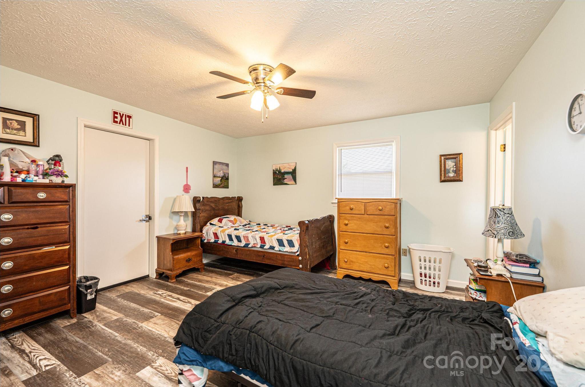 1221 Connelly Springs Road Lenoir, NC 28645 - Photo 23 of 42 a bedroom with a bed and wooden floor