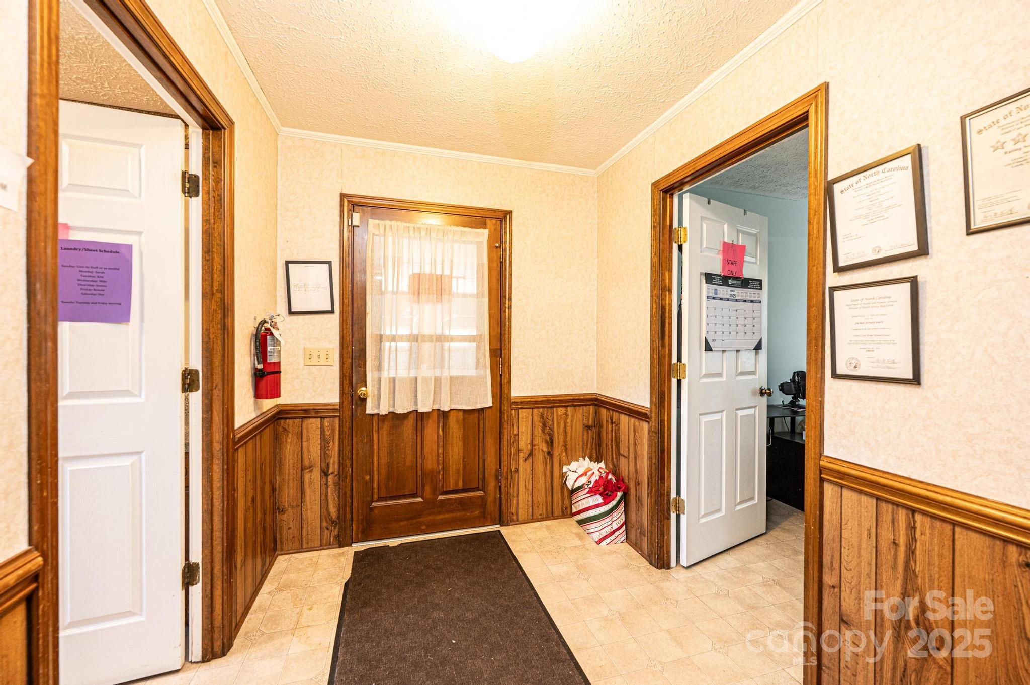 1221 Connelly Springs Road Lenoir, NC 28645 - Photo 24 of 42 a view of a hallway with wooden floor and windows