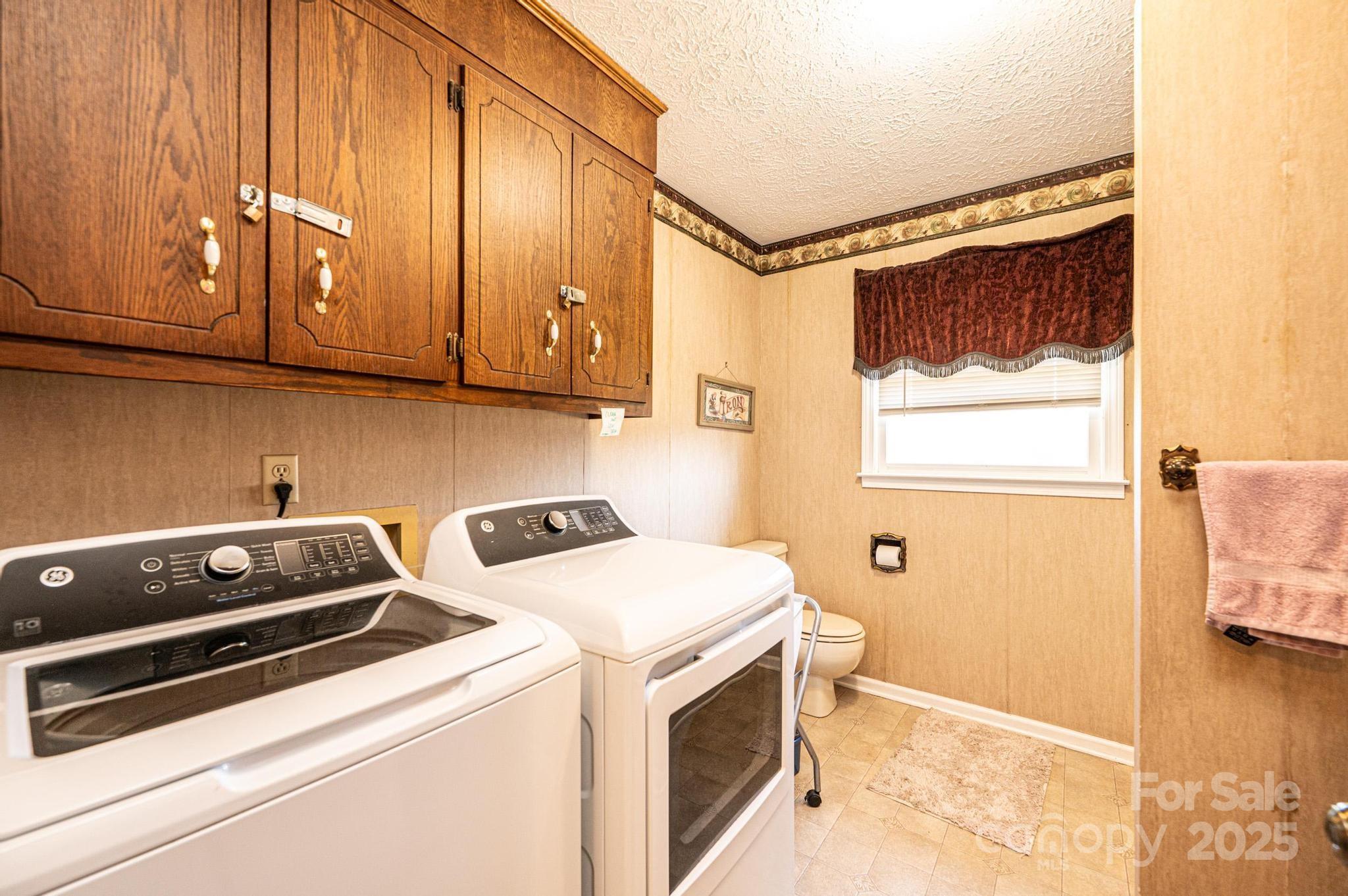 1221 Connelly Springs Road Lenoir, NC 28645 - Photo 25 of 42 a utility room with dryer and washer