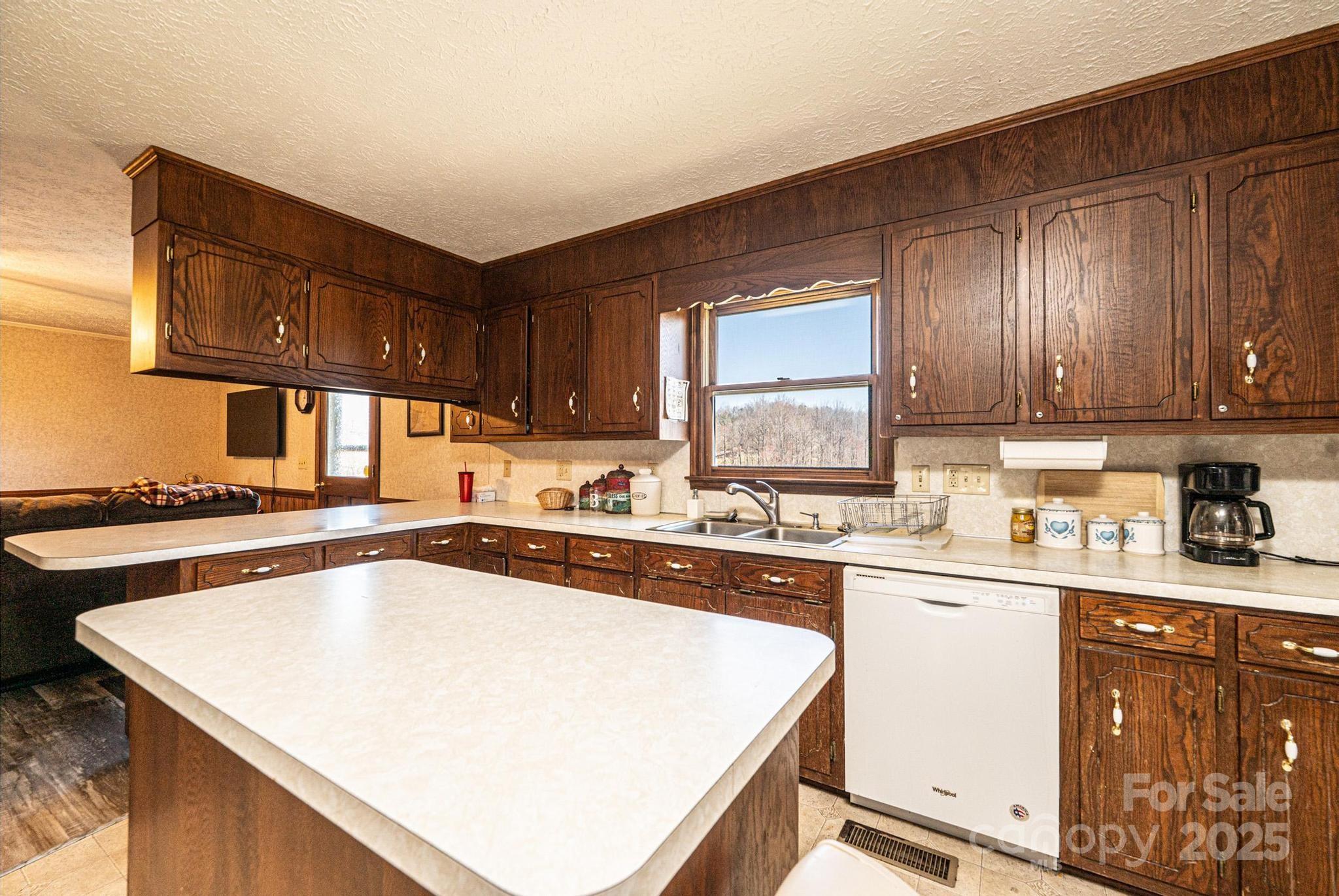 1221 Connelly Springs Road Lenoir, NC 28645 - Photo 31 of 42 a kitchen with a sink a stove and cabinets