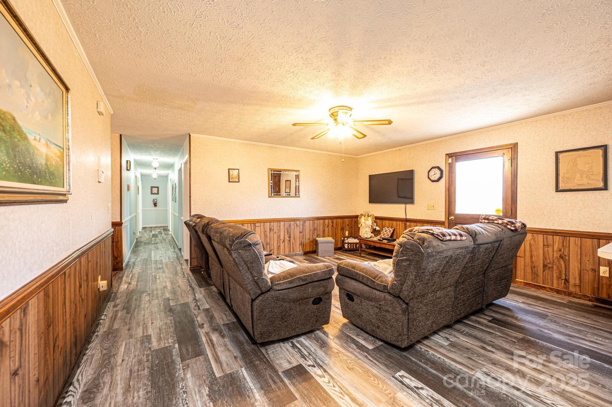 1221 Connelly Springs Road Lenoir, NC 28645 - Photo 33 of 42 a living room with furniture and a wooden floor