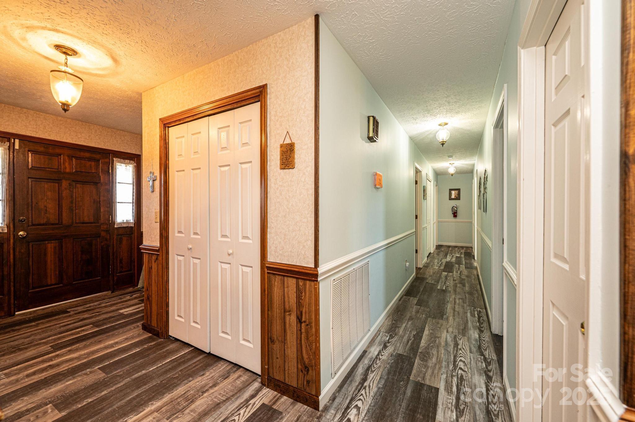 1221 Connelly Springs Road Lenoir, NC 28645 - Photo 35 of 42 a view of a hallway with wooden floor and staircase