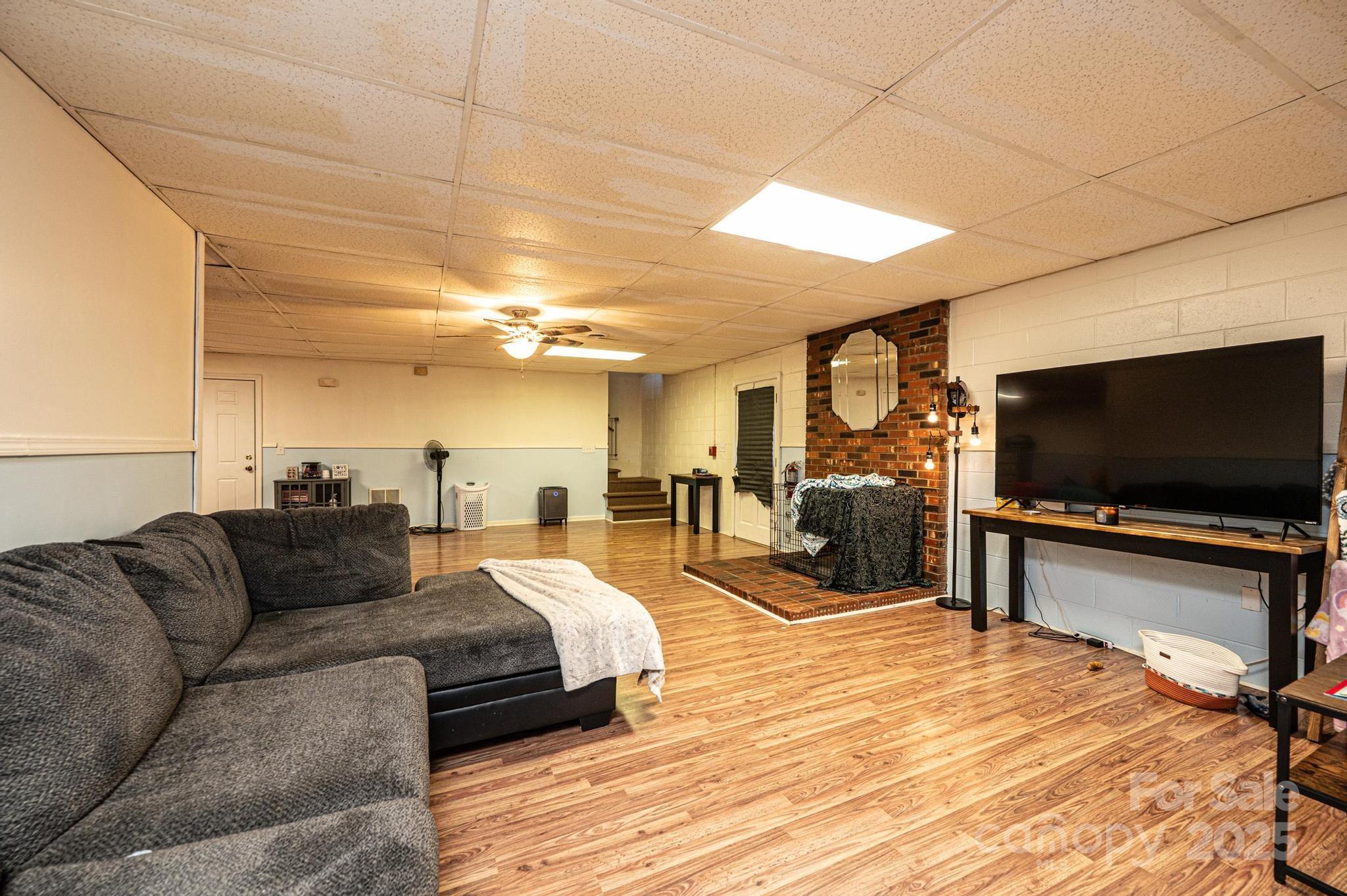 1221 Connelly Springs Road Lenoir, NC 28645 - Photo 37 of 42 a living room with furniture and a flat screen tv