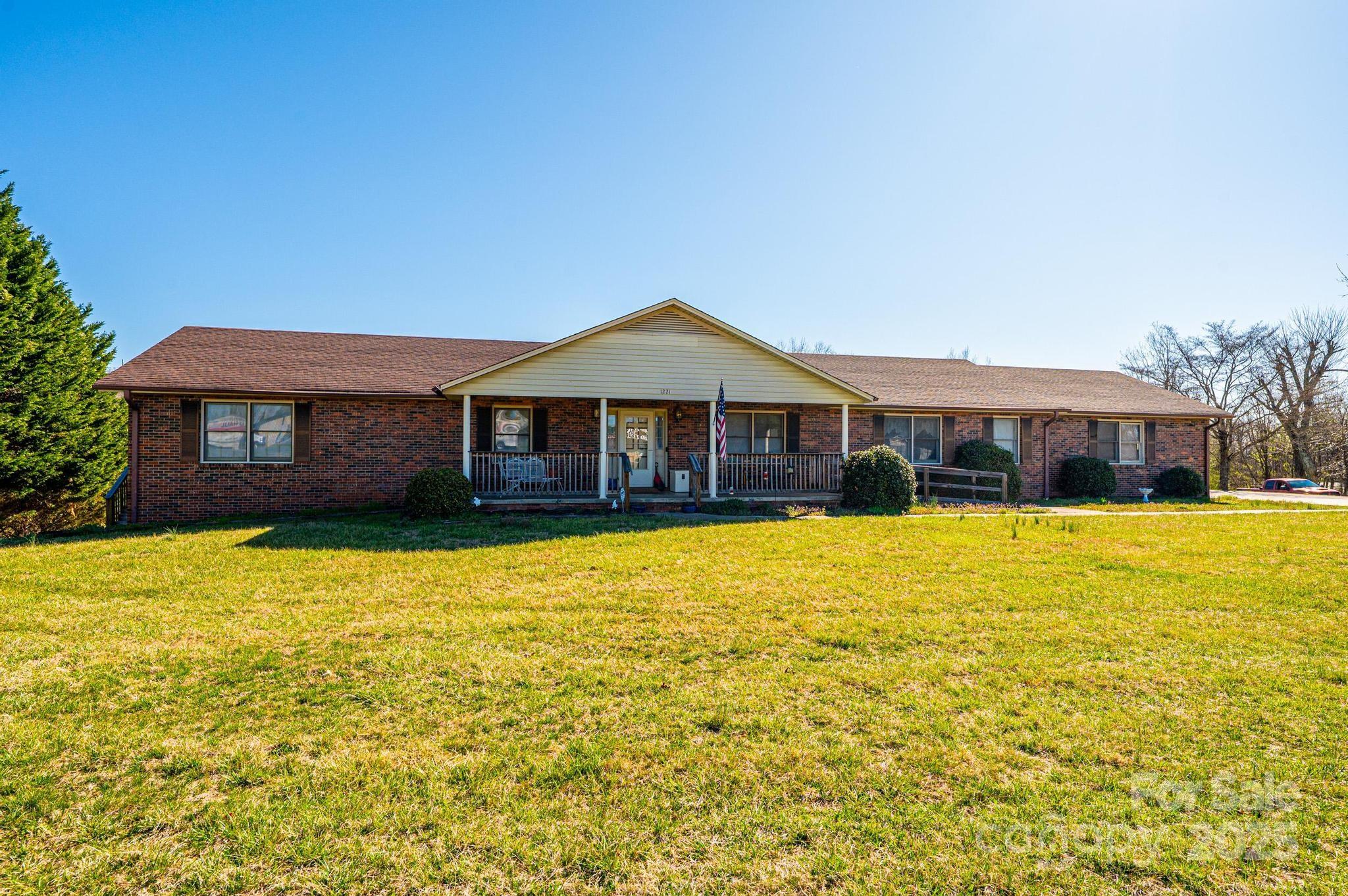 1221 Connelly Springs Road Lenoir, NC 28645 - Photo 4 of 42 a front view of a house with a yard