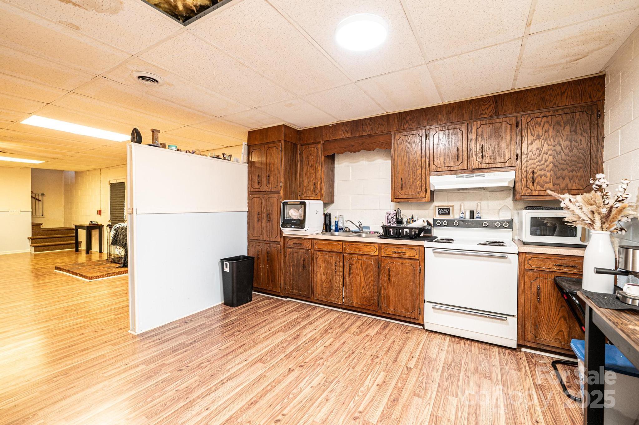 1221 Connelly Springs Road Lenoir, NC 28645 - Photo 42 of 42 a kitchen with a refrigerator and a stove top oven
