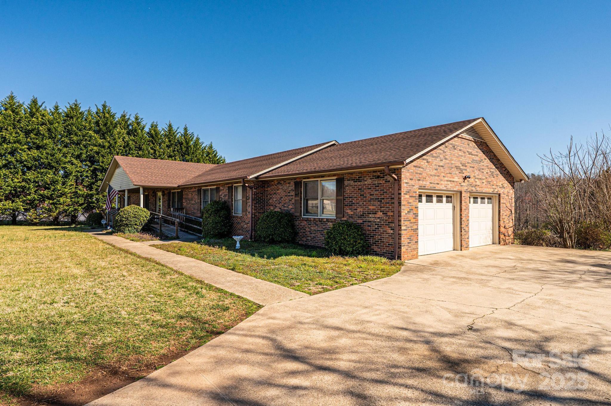 1221 Connelly Springs Road Lenoir, NC 28645 - Photo 5 of 42 a front view of a house with a yard