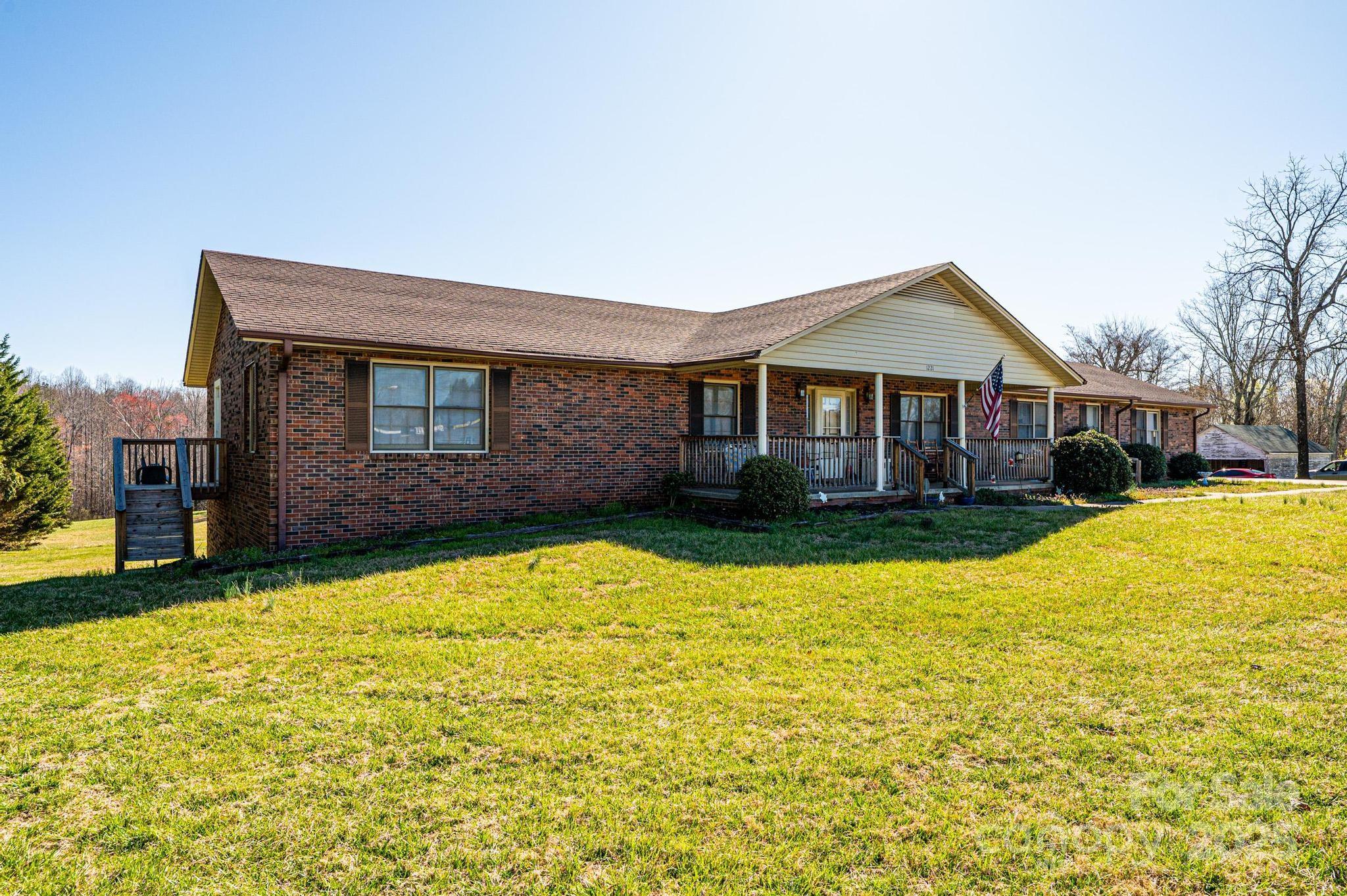 1221 Connelly Springs Road Lenoir, NC 28645 - Photo 6 of 42 a front view of a house with a yard