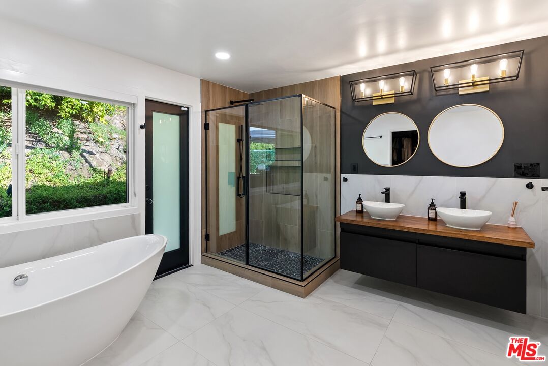 4118 Oak Hollow Road Calabasas, CA 91302 - Photo 38 of 55 a bathroom with a double vanity sink mirror and bathtub
