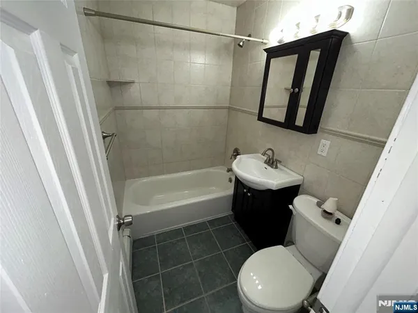 a view of room with a ceiling fan and window