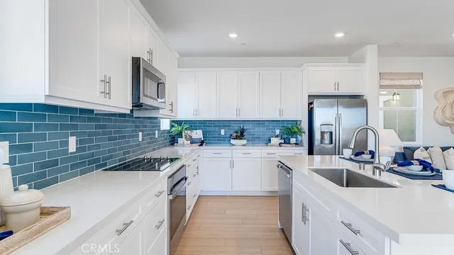 a kitchen with a sink cabinets and appliances