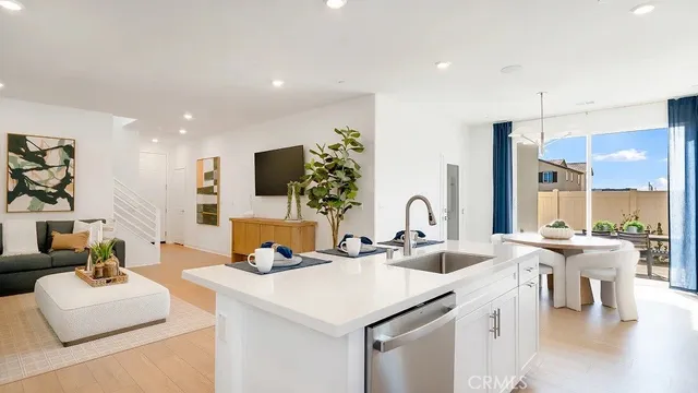 a living room with furniture a flat screen tv and a large window