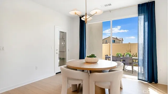 a kitchen with a table and a chandelier