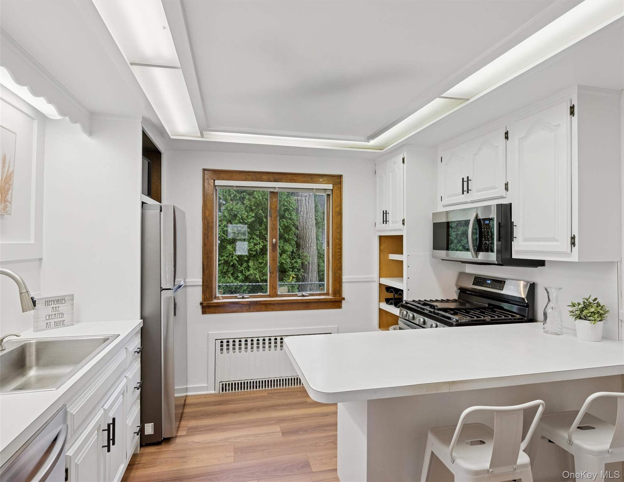 148 Woodhull Avenue Riverside, NY 11901 - Photo 11 of 20 a kitchen with stainless steel appliances a stove a sink and a refrigerator