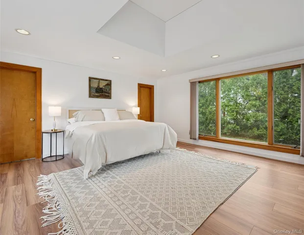 a bedroom with a large bed and a large window