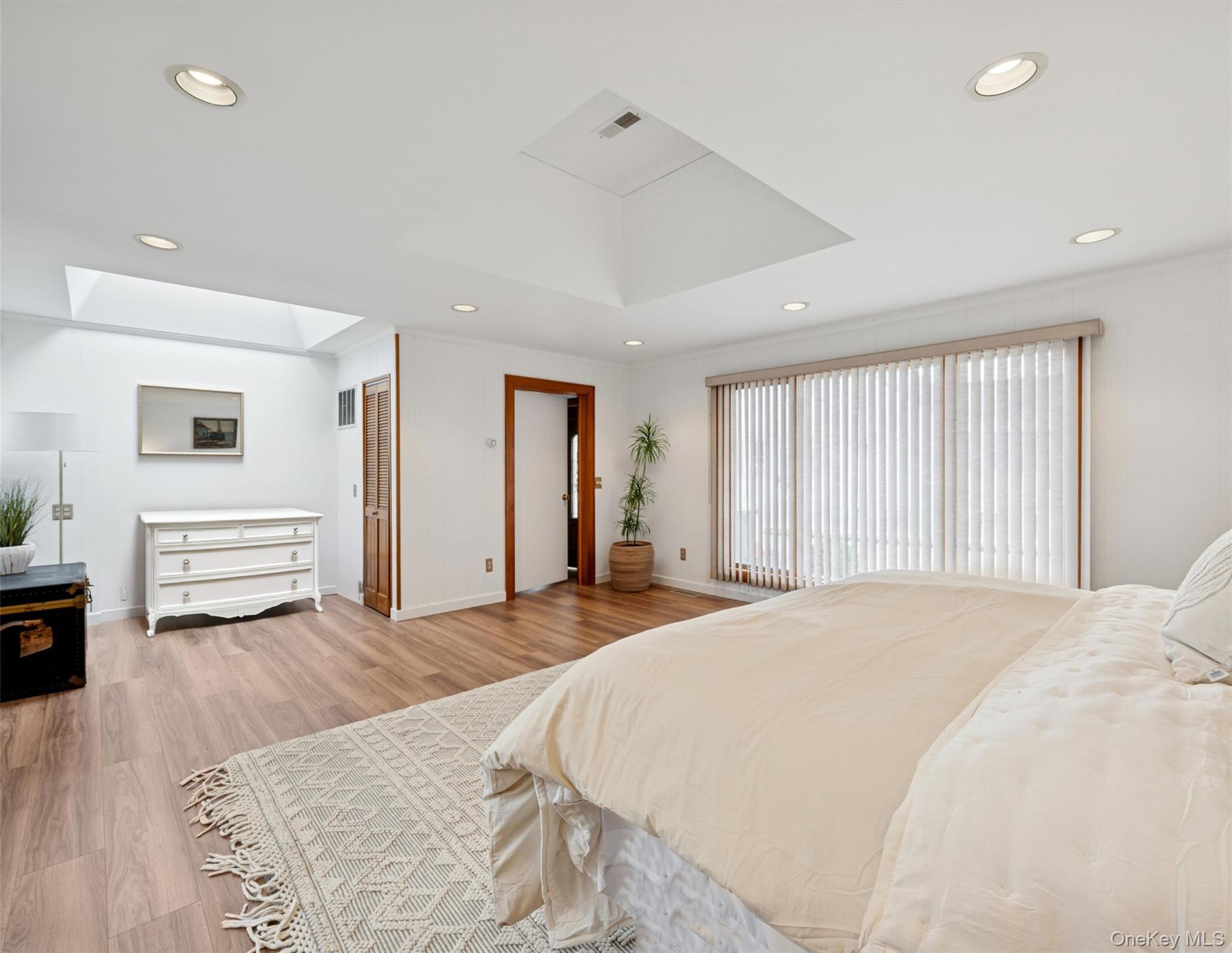 148 Woodhull Avenue Riverside, NY 11901 - Photo 15 of 20 a spacious bedroom with a large bed and a large window