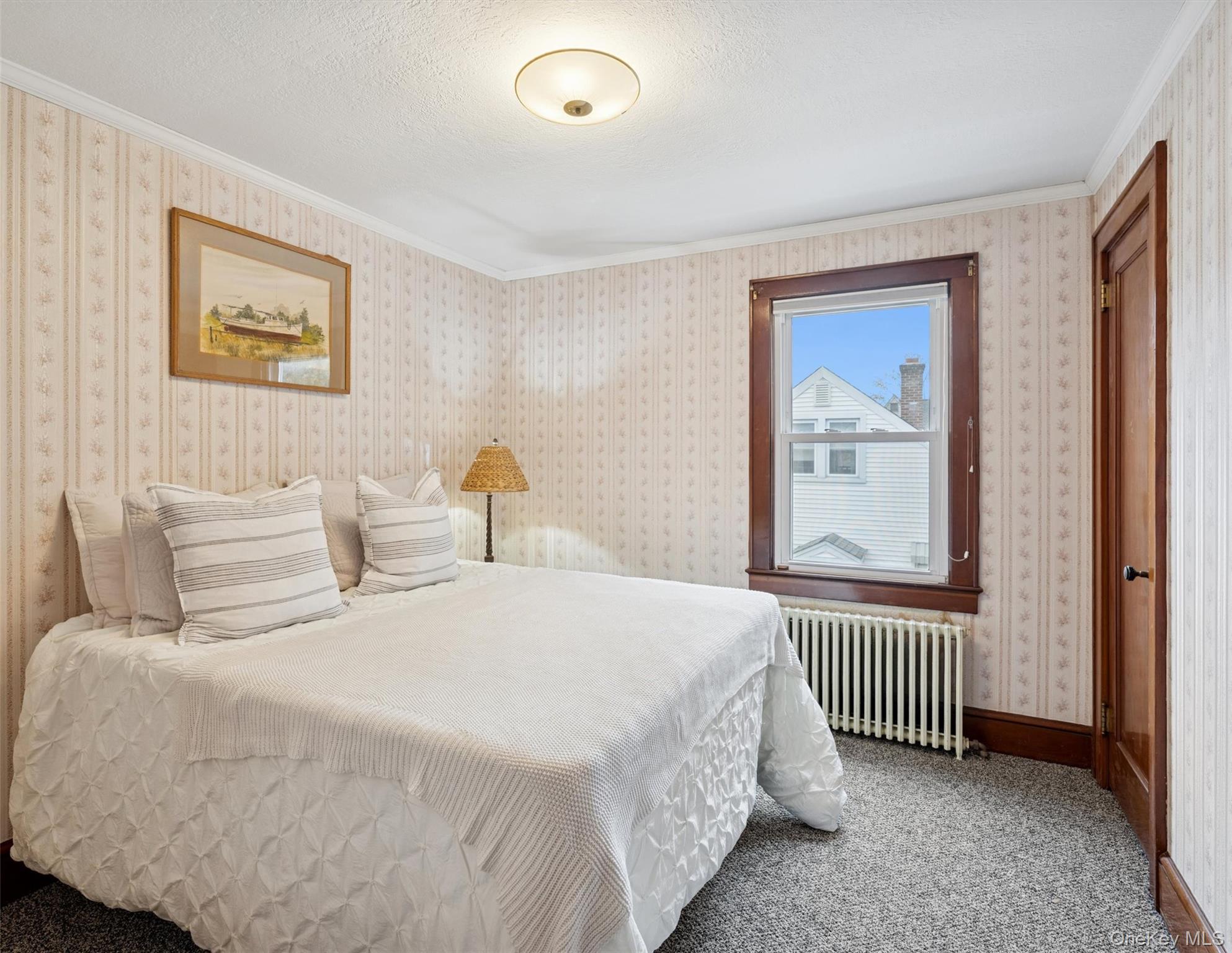 148 Woodhull Avenue Riverside, NY 11901 - Photo 18 of 20 a bedroom with a bed and a window