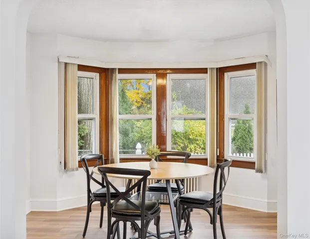 a view of a dining room with furniture window and wooden floor
