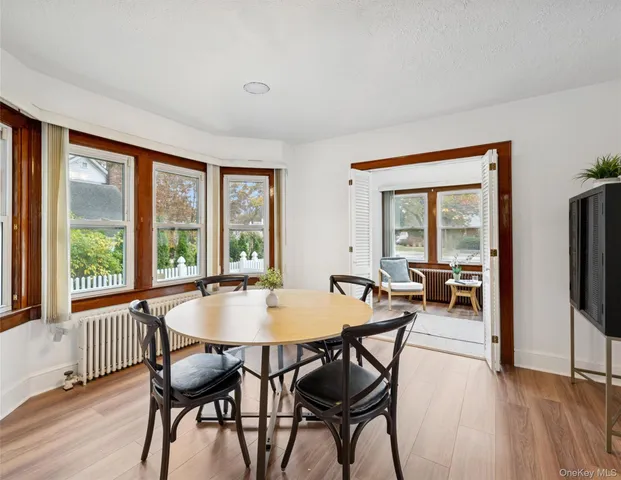 a dining room with furniture and wooden floor