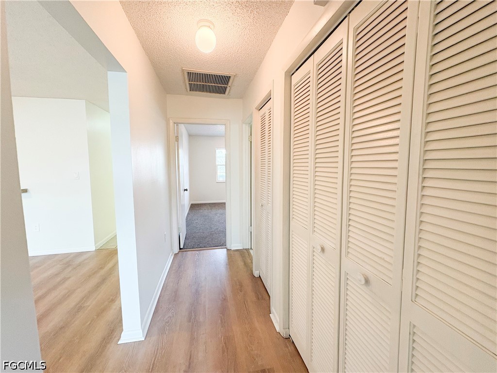 1830 Brantley Road, Unit I7 Fort Myers, FL 33907 - Photo 15 of 34 a view of a hallway with wooden floor