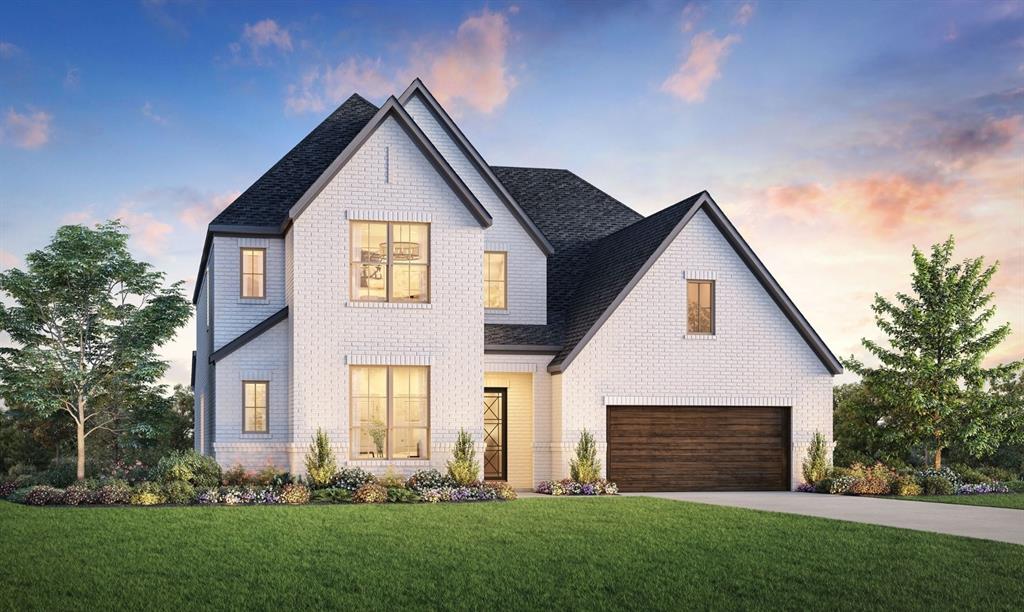 a front view of a house with a yard and green space