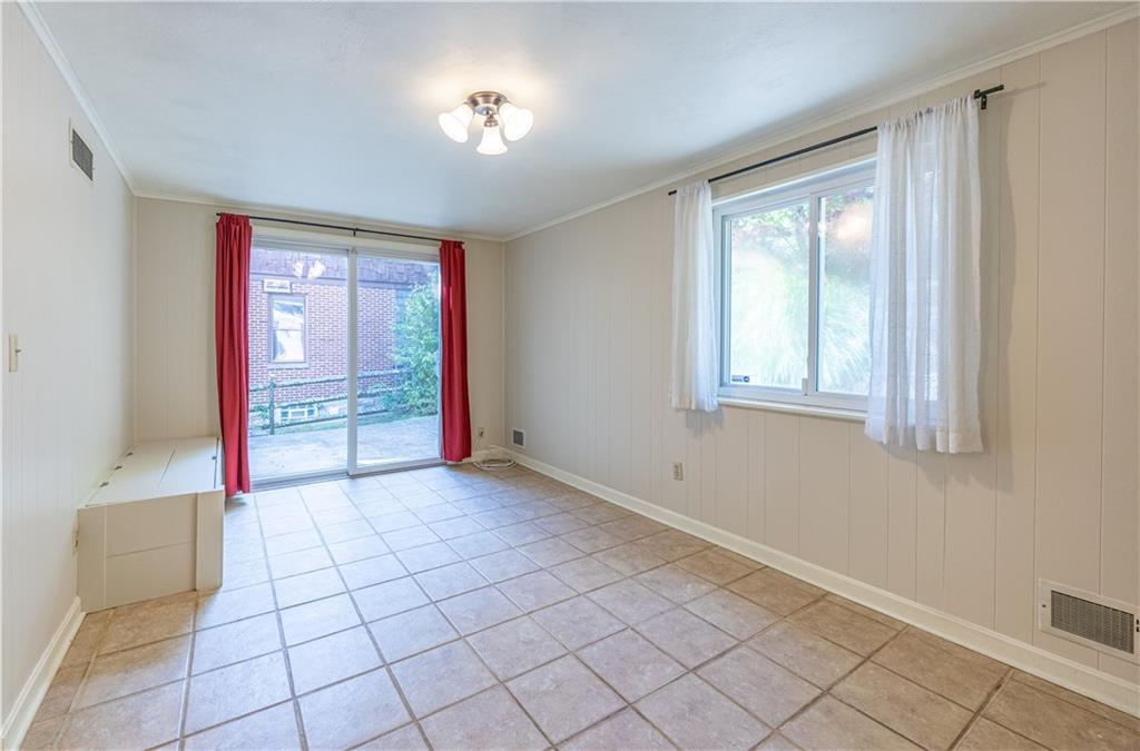 103 Cherry Valley Road Pittsburgh, PA 15221 - Photo 13 of 29 a view of an empty room with window and chandelier fan