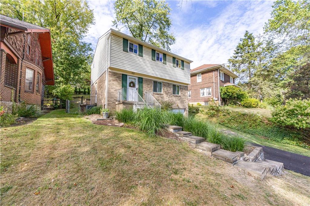 103 Cherry Valley Road Pittsburgh, PA 15221 - Photo 2 of 29 a front view of a house with a garden