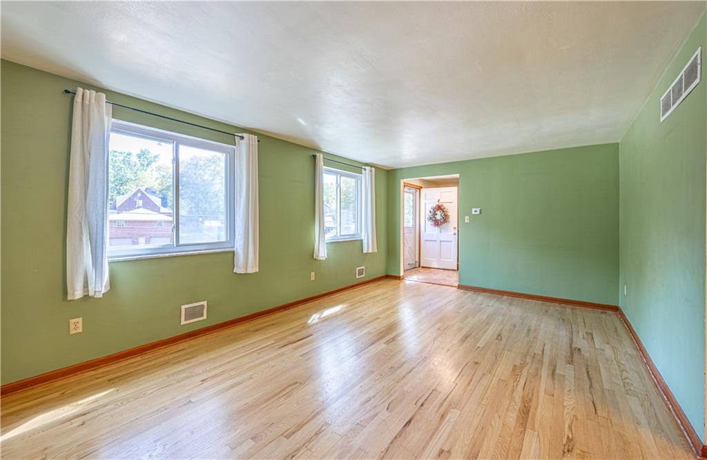 103 Cherry Valley Road Pittsburgh, PA 15221 - Photo 4 of 29 a view of empty room with wooden floor and fan