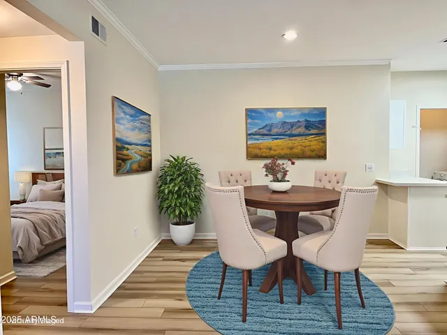 a view of a dining room with furniture and wooden floor