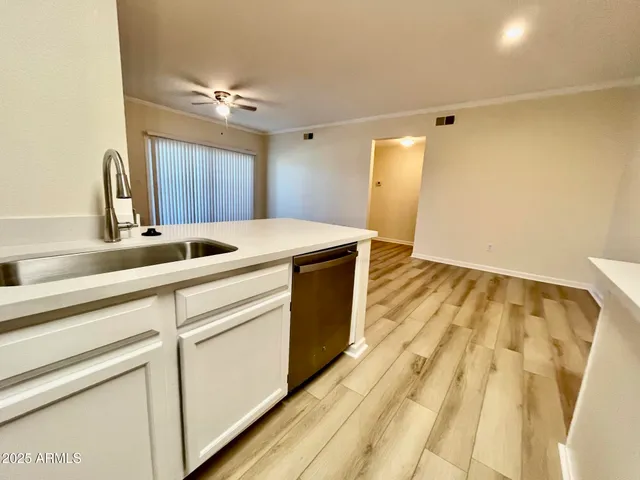 a kitchen with a sink and a mirror