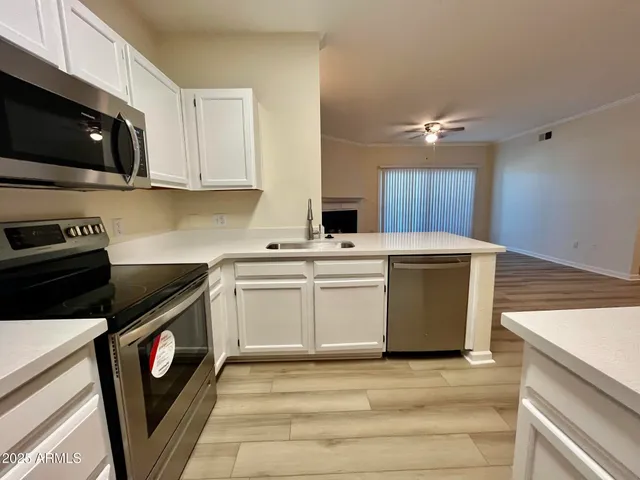 a view of a kitchen with electric appliances